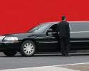 Elegant black stretch limousine with driver.