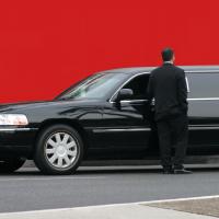 Elegant black stretch limousine with driver.